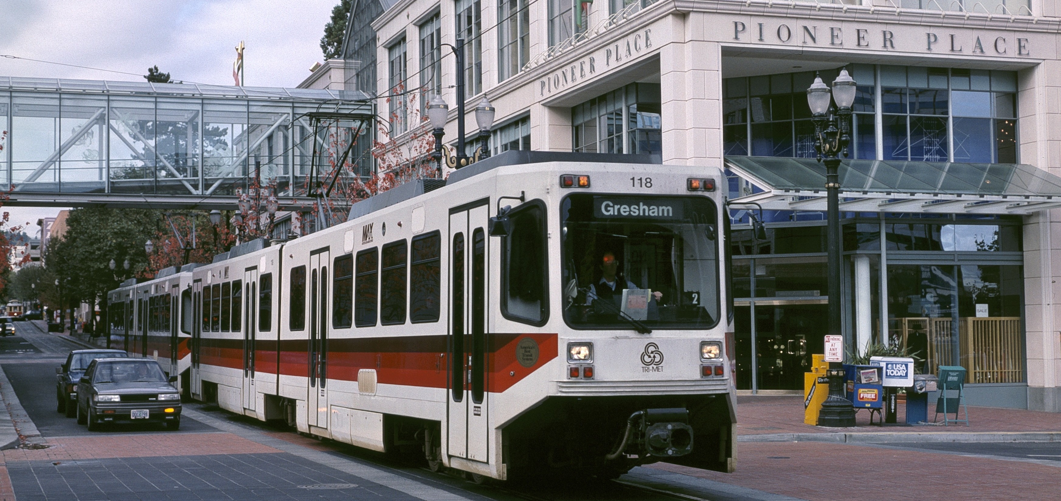 MAX_train_on_Yamhill_St_with_Pioneer_Place_1991_-_Portland_Oregon-e1430466766468